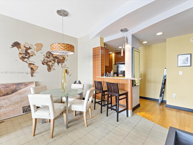 dining space with light hardwood / wood-style floors