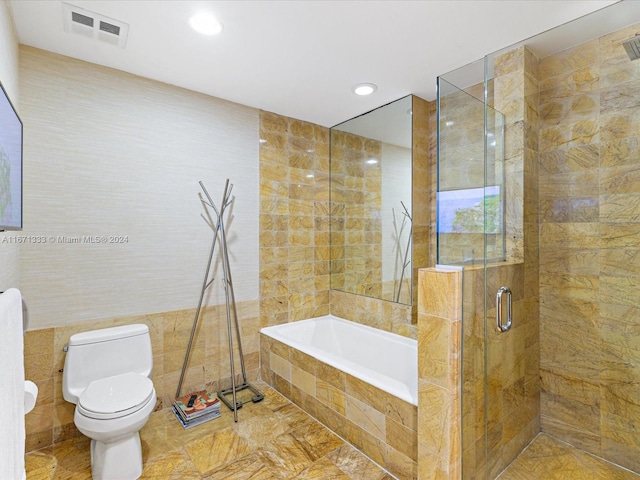 bathroom with independent shower and bath, toilet, and tile walls