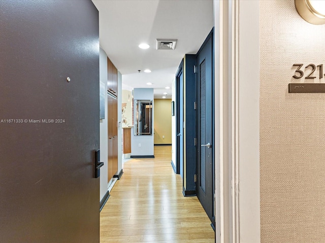 corridor with light wood-type flooring