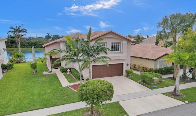 view of front of property with a water view, a front yard, and a garage