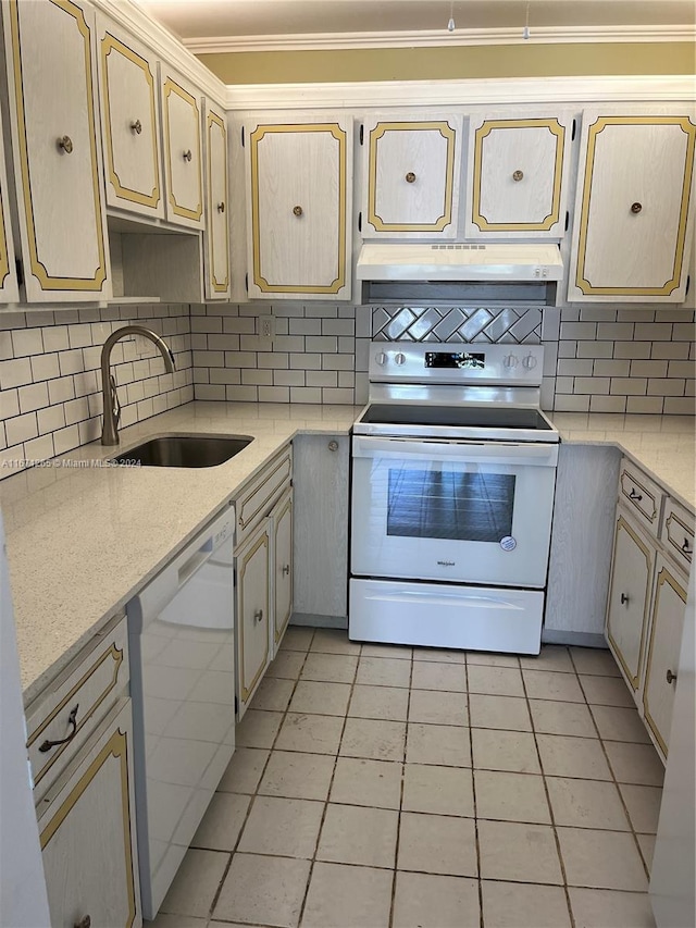 kitchen featuring light tile patterned flooring, tasteful backsplash, white appliances, ornamental molding, and sink