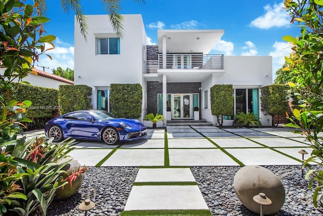 2382 Alton Rd, Miami Beach, FL 33140 - back of house with french doors, stucco siding, stone siding, and a balcony