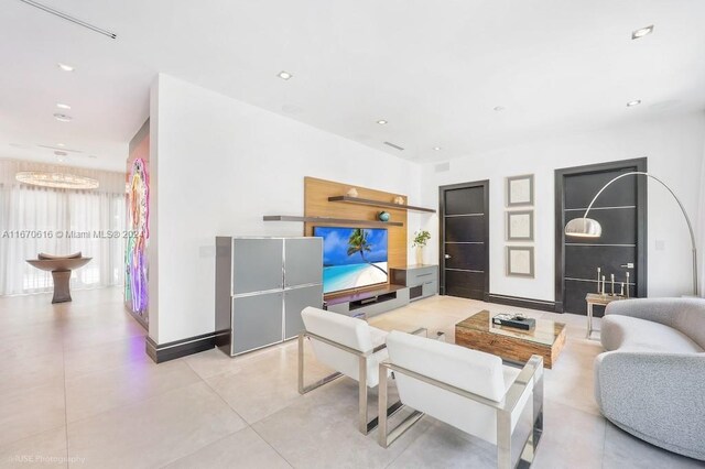 2382 Alton Rd, Miami Beach, FL 33140 - living area featuring a chandelier, recessed lighting, baseboards, and light tile patterned floors