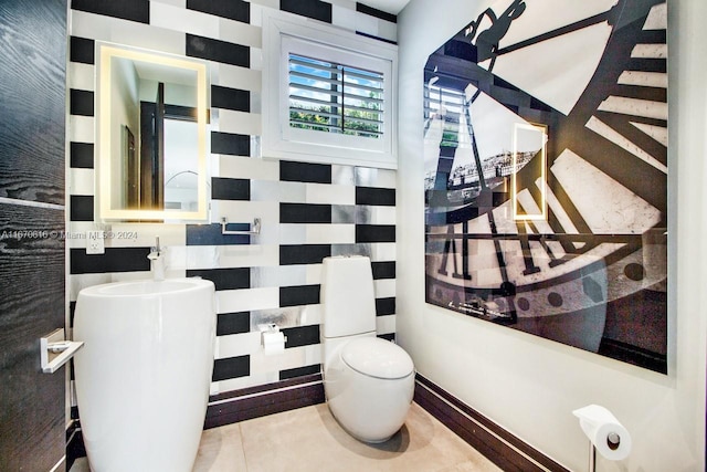 bathroom featuring tile patterned floors, vanity, toilet, and tile walls