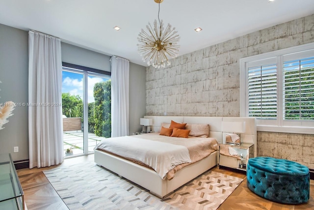 bedroom featuring a notable chandelier, access to exterior, and light parquet flooring