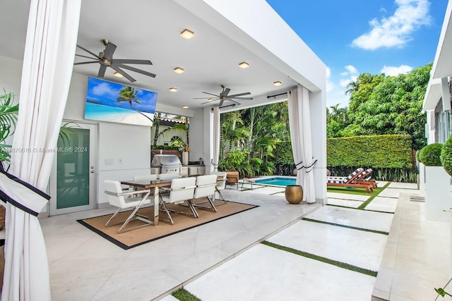 view of patio / terrace with ceiling fan, area for grilling, and a fenced in pool