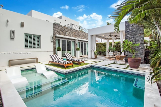 rear view of property featuring a patio and ceiling fan