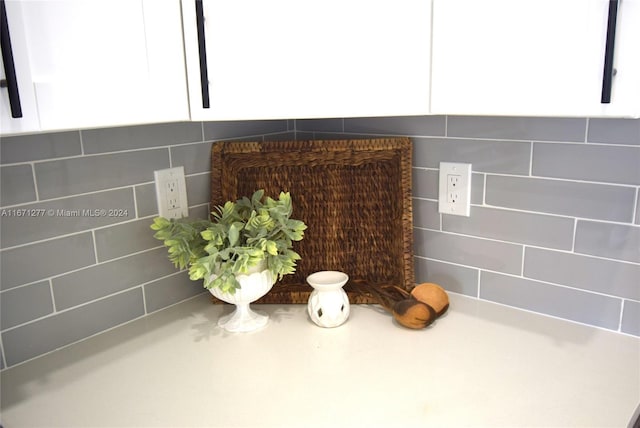 details with white cabinets and backsplash