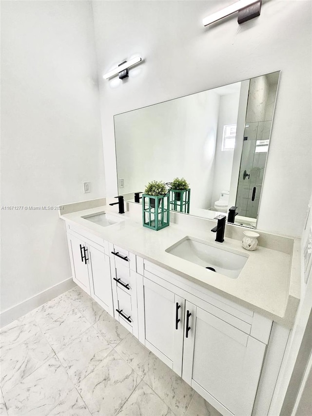 bathroom with walk in shower, vanity, and toilet