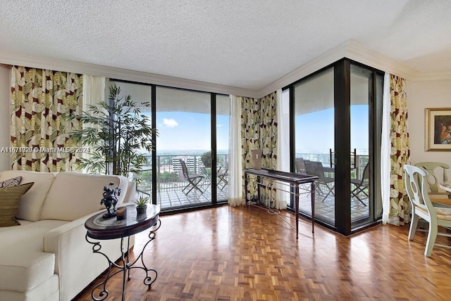 living room with a wall of windows, crown molding, a textured ceiling, and parquet flooring