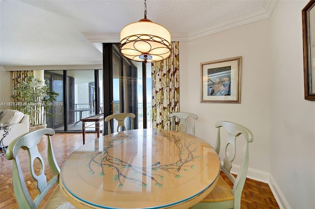 dining area featuring a textured ceiling, parquet floors, ornamental molding, and expansive windows