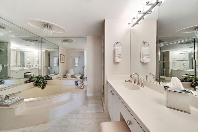 bathroom featuring vanity, a washtub, and toilet