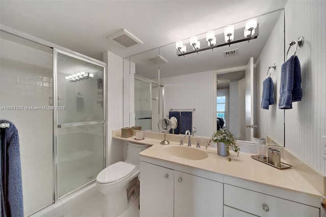 bathroom with tile patterned floors, an enclosed shower, vanity, and toilet