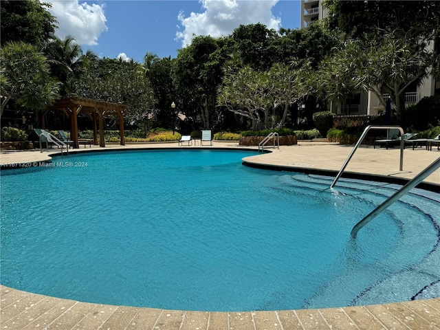 view of swimming pool with a pergola