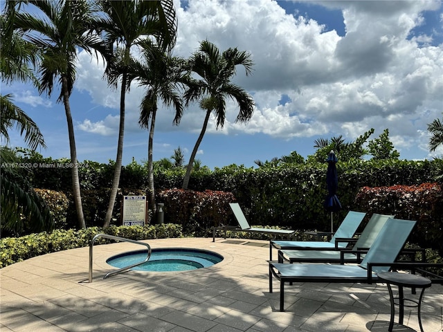 view of pool featuring a community hot tub and a patio area