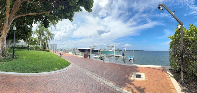 view of dock featuring a yard and a water view