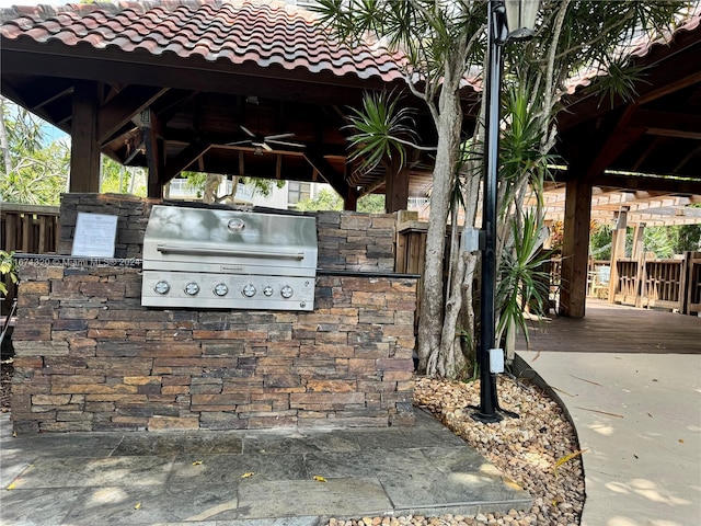 view of patio / terrace featuring ceiling fan, area for grilling, a grill, and a gazebo