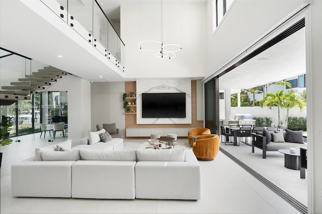 living room with a high ceiling and plenty of natural light