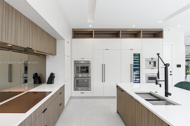 kitchen featuring white cabinets, white double oven, light tile patterned floors, black electric cooktop, and double oven