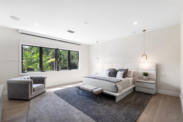 bedroom with dark hardwood / wood-style floors