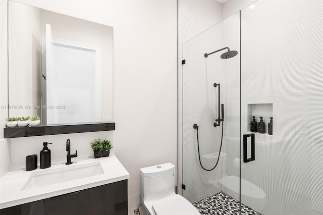 bathroom with vanity, toilet, and a shower with door