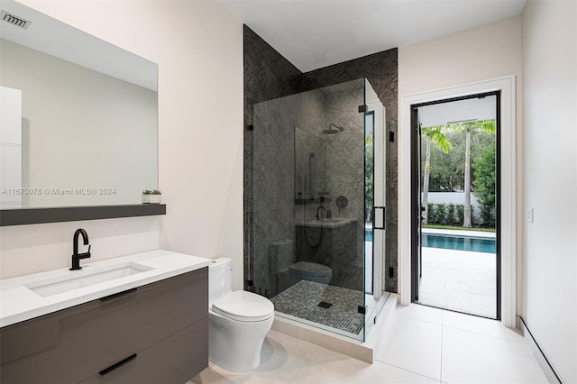 bathroom featuring vanity, a shower with shower door, toilet, and tile patterned flooring