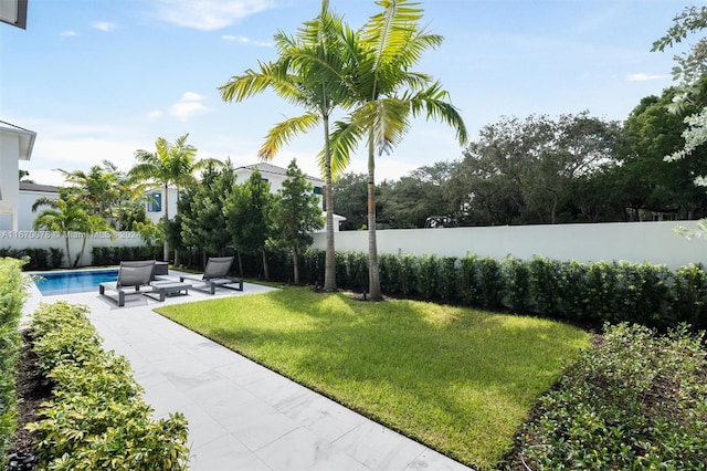 view of property's community with a lawn, a patio, and a pool