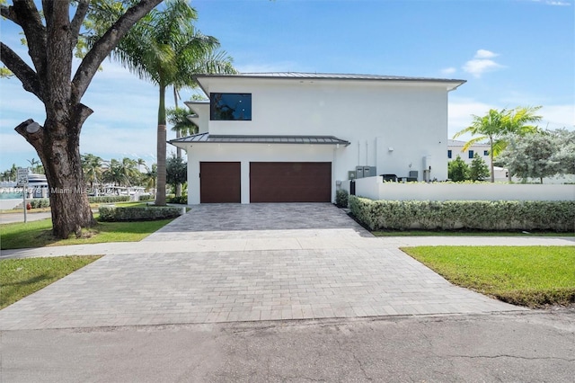 view of front facade with a front yard and a garage