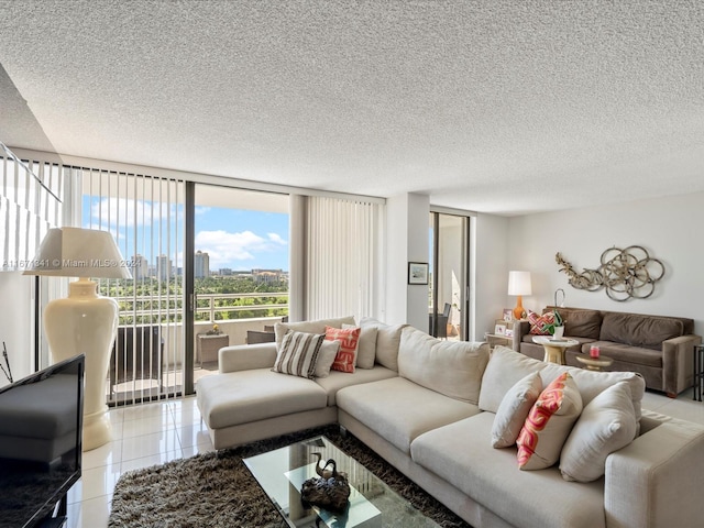 living room featuring expansive windows, a textured ceiling, and light tile patterned floors