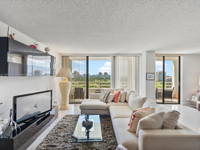 living room featuring a textured ceiling, floor to ceiling windows, light tile patterned floors, and plenty of natural light