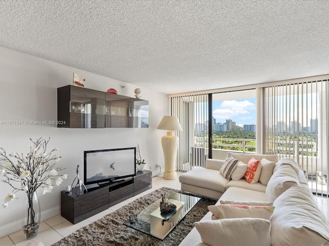 living room with a textured ceiling and light tile patterned floors