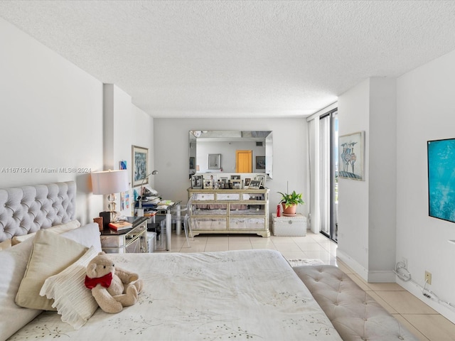 tiled bedroom with a textured ceiling