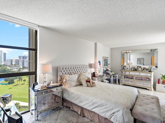 bedroom featuring expansive windows and a textured ceiling