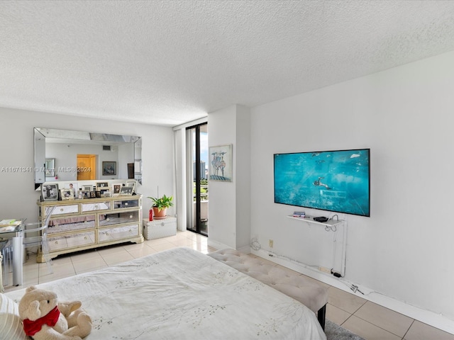 bedroom with a textured ceiling and light tile patterned floors