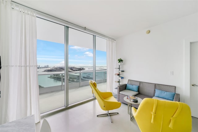 living room with floor to ceiling windows and a water view