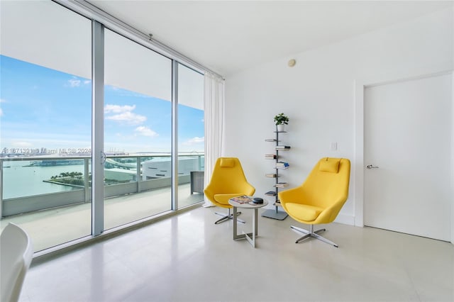 living area featuring expansive windows and a water view