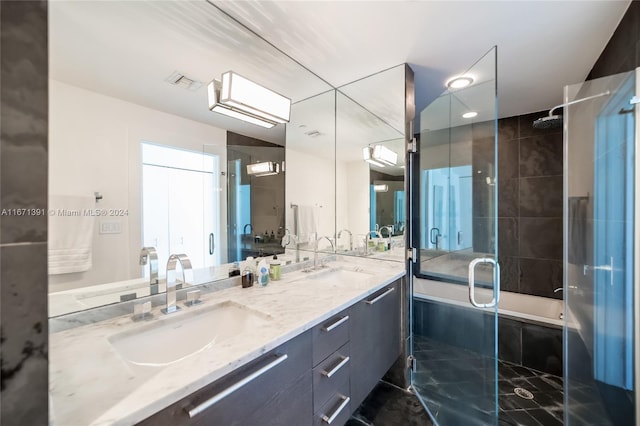 bathroom with a shower with shower door and vanity