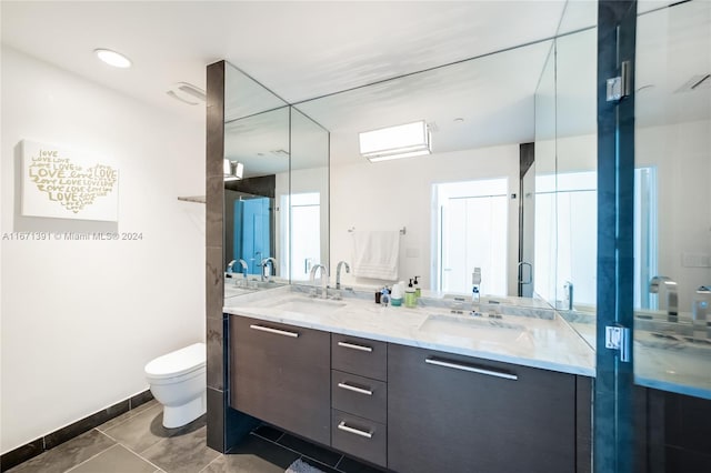 bathroom featuring tile patterned flooring, vanity, and toilet