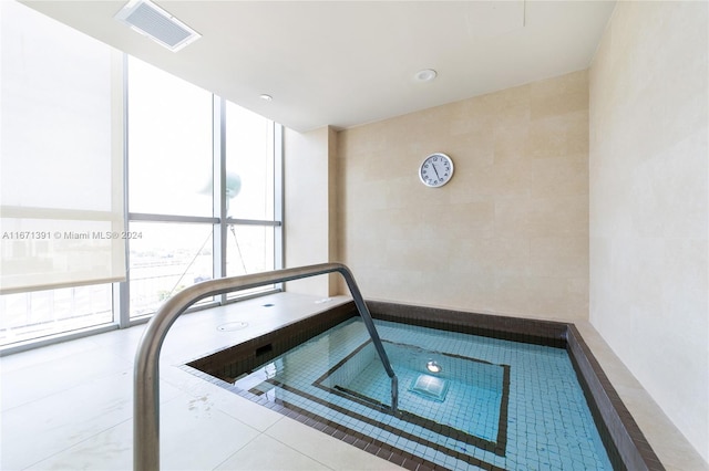 view of swimming pool with an indoor in ground hot tub