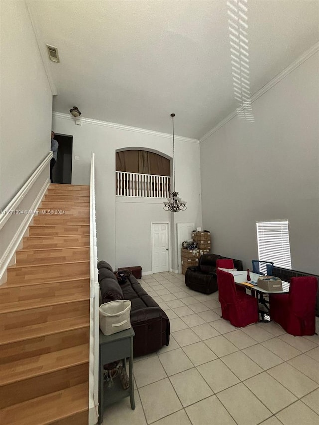 living room featuring light tile patterned flooring and crown molding