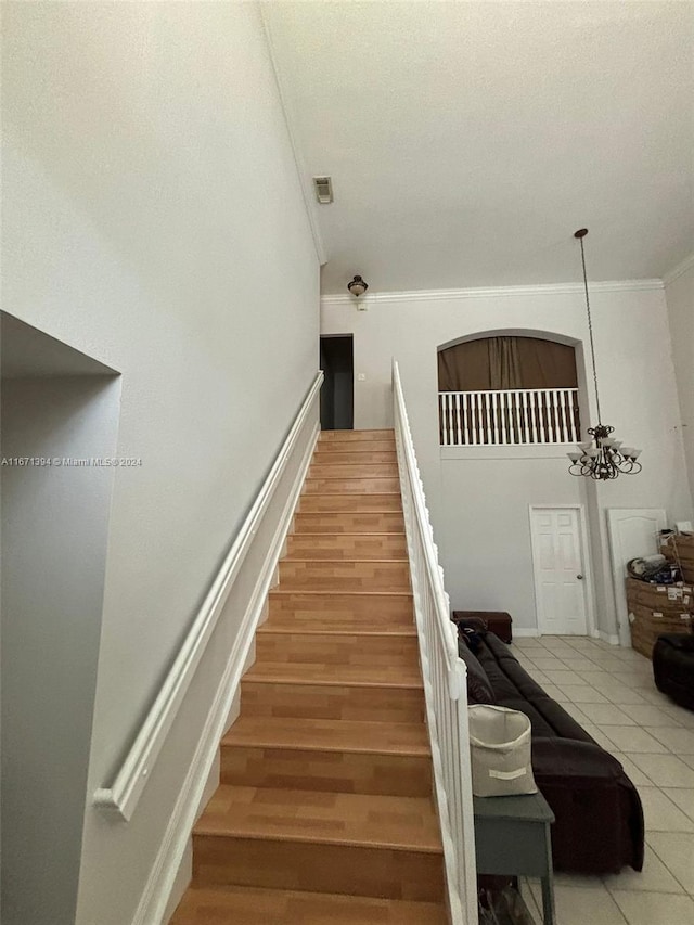 stairs with a chandelier and hardwood / wood-style floors