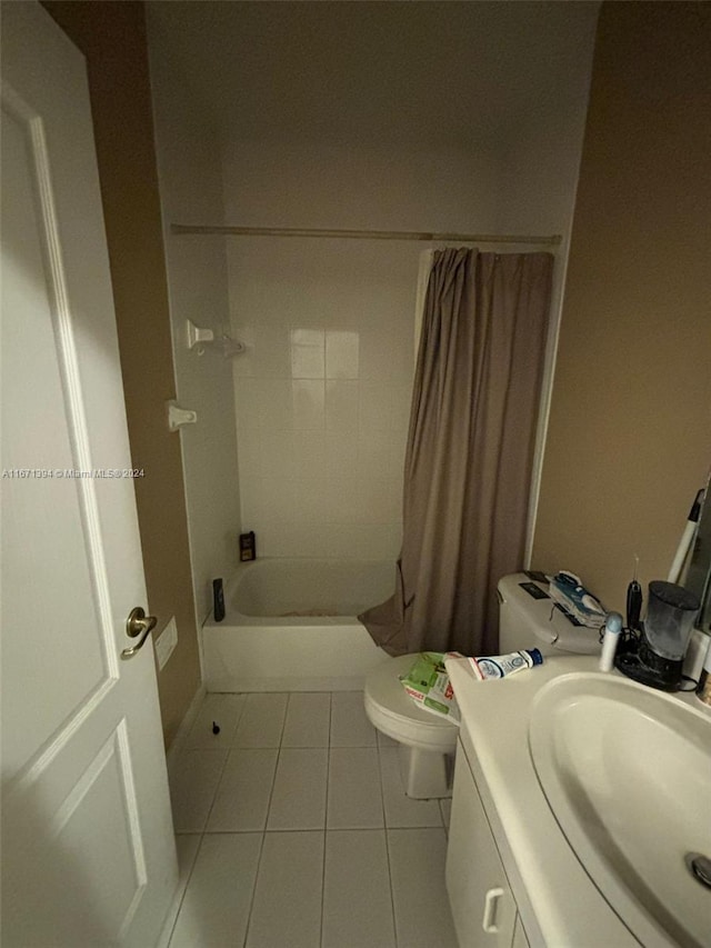 full bathroom featuring shower / bath combination with curtain, vanity, tile patterned flooring, and toilet