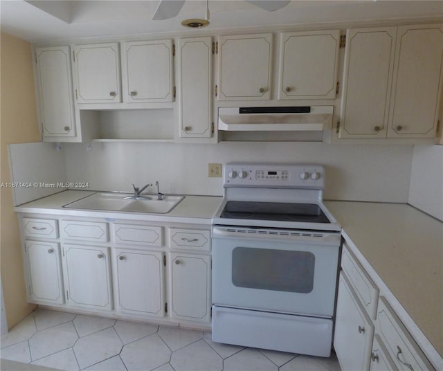 kitchen featuring white cabinetry, electric range, and sink