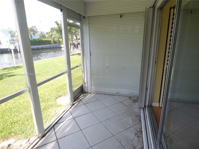 unfurnished sunroom with a water view