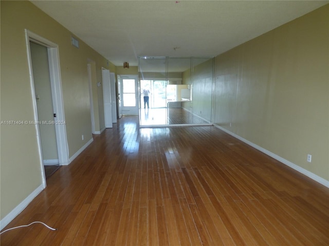 empty room with hardwood / wood-style floors