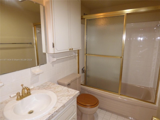 full bathroom featuring tasteful backsplash, vanity, enclosed tub / shower combo, toilet, and tile patterned floors