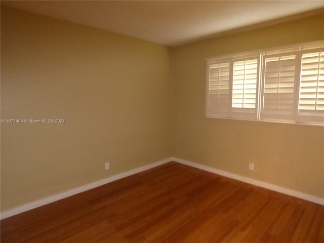 empty room with hardwood / wood-style flooring