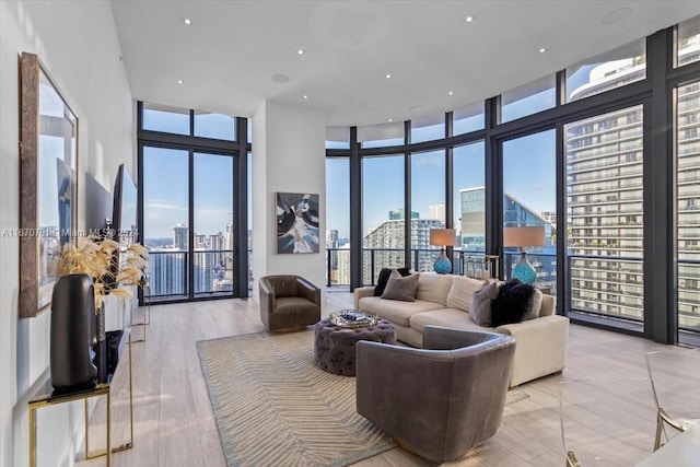 living room featuring expansive windows, a high ceiling, and a wealth of natural light