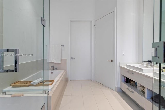 bathroom featuring vanity, tile patterned flooring, and a tub