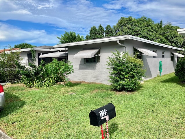 view of side of home featuring a yard